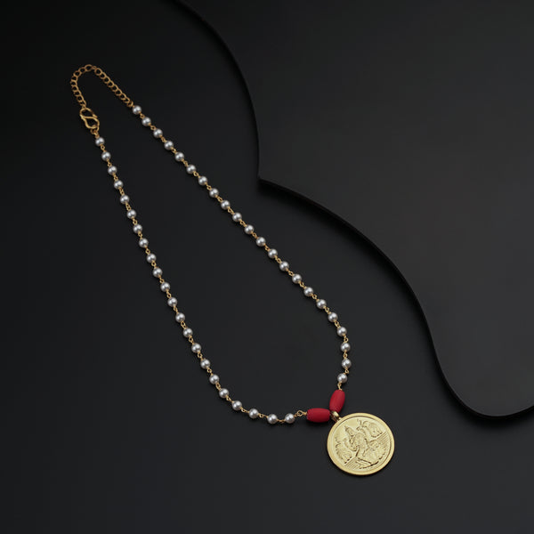 a necklace with a coin on a black surface