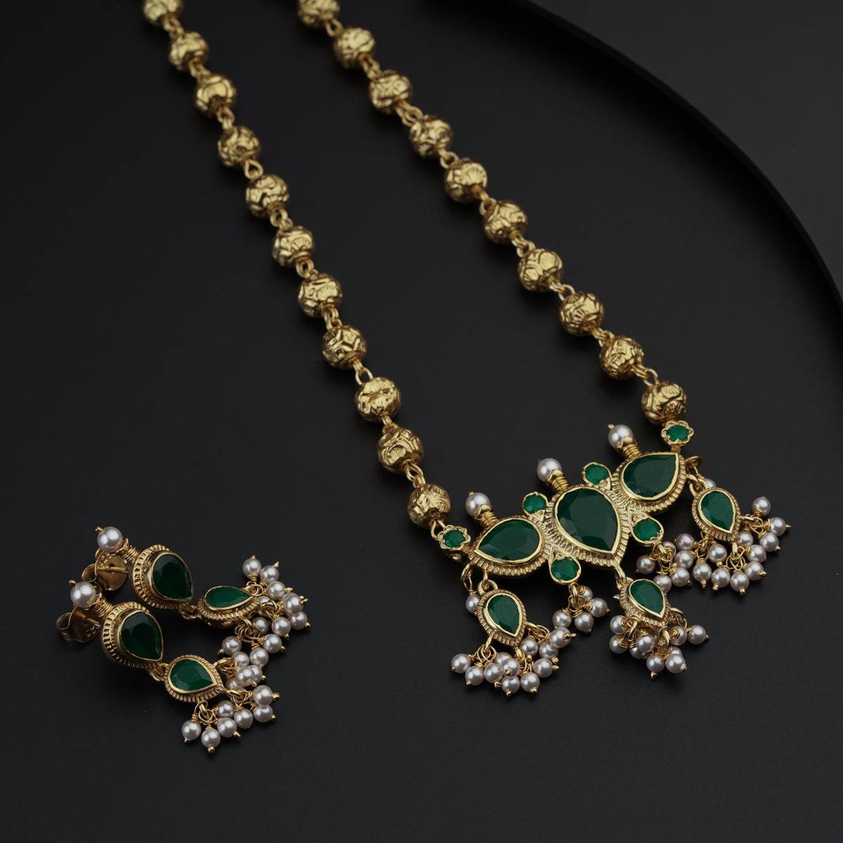 a green and gold necklace and earring set