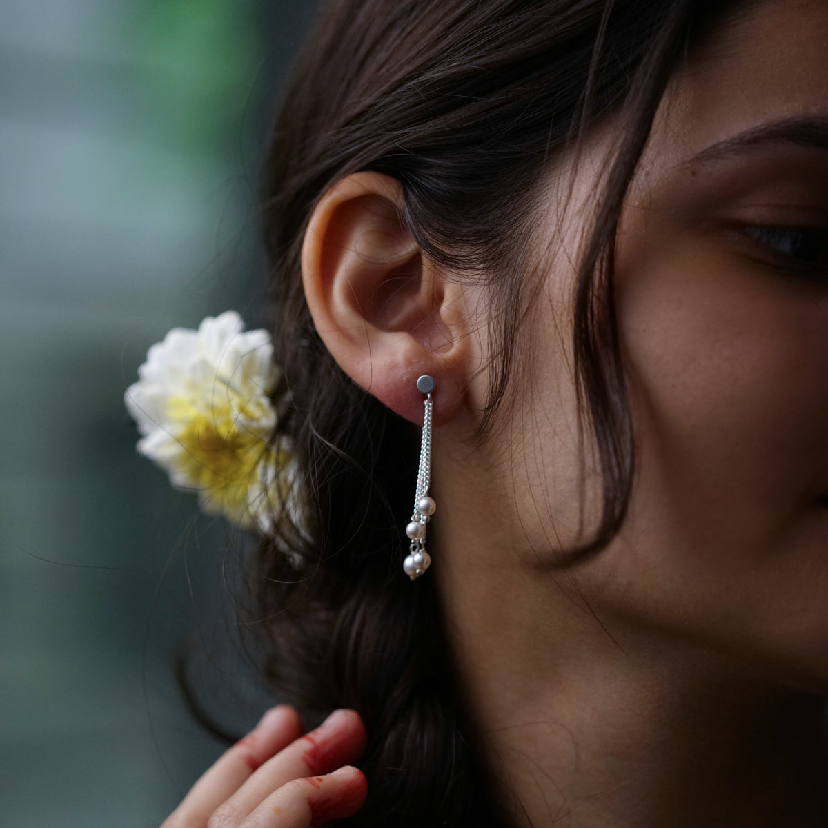a woman with a flower in her ear