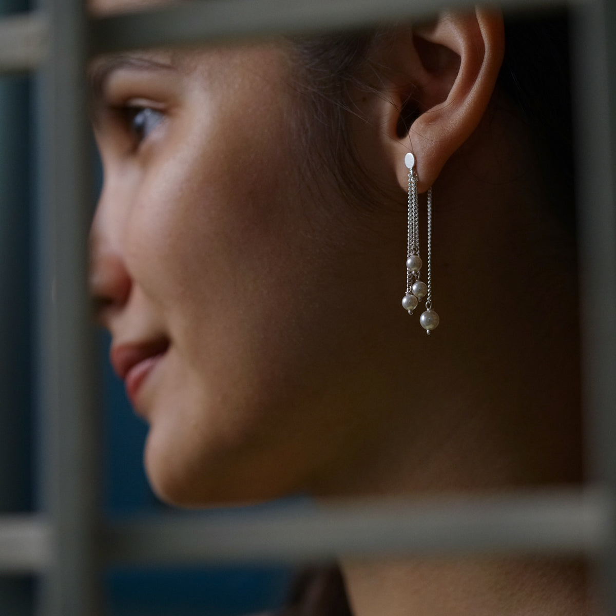 a close up of a person wearing a pair of earrings