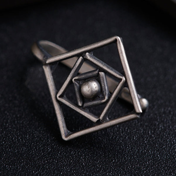 a ring with two balls inside of it