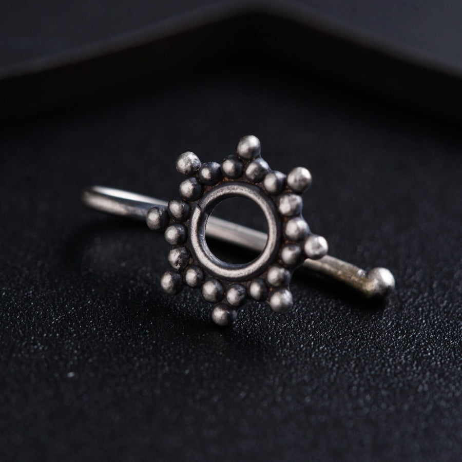 a close up of a ring on a black surface