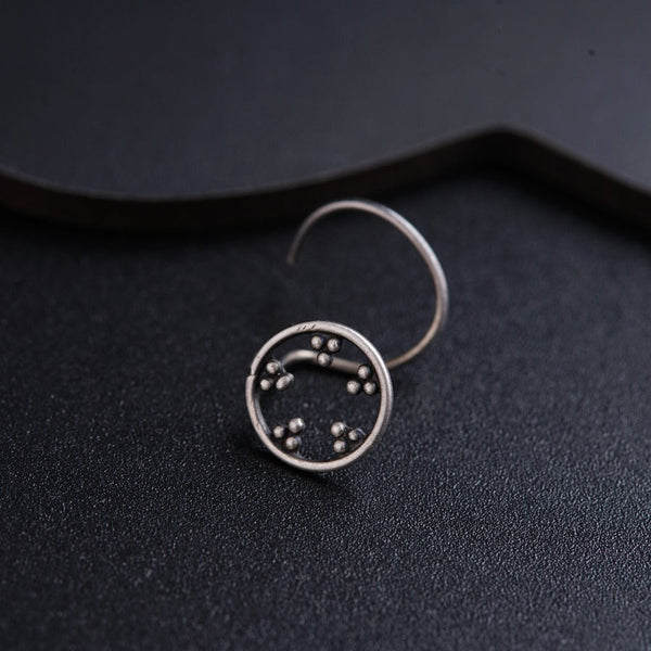 a close up of a clock on a black surface