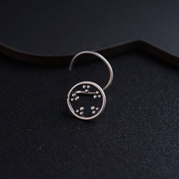 a close up of a clock on a black surface