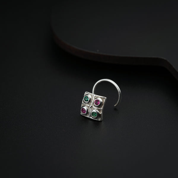 a close up of a pair of earrings on a black surface