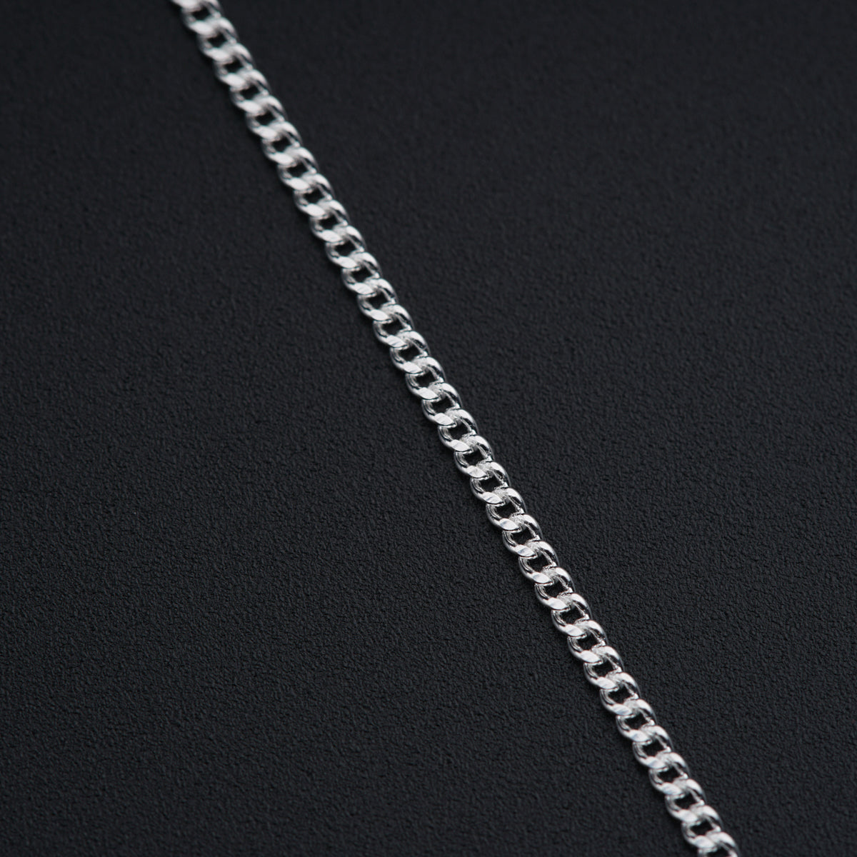 a close up of a chain on a black surface