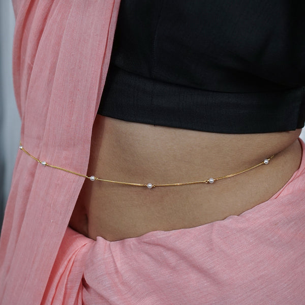 Gold plated pearl waist chain on model's waist