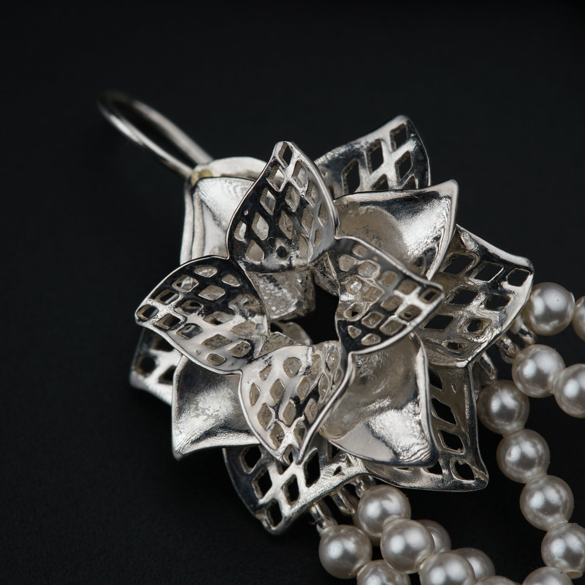 a close up of a necklace with pearls