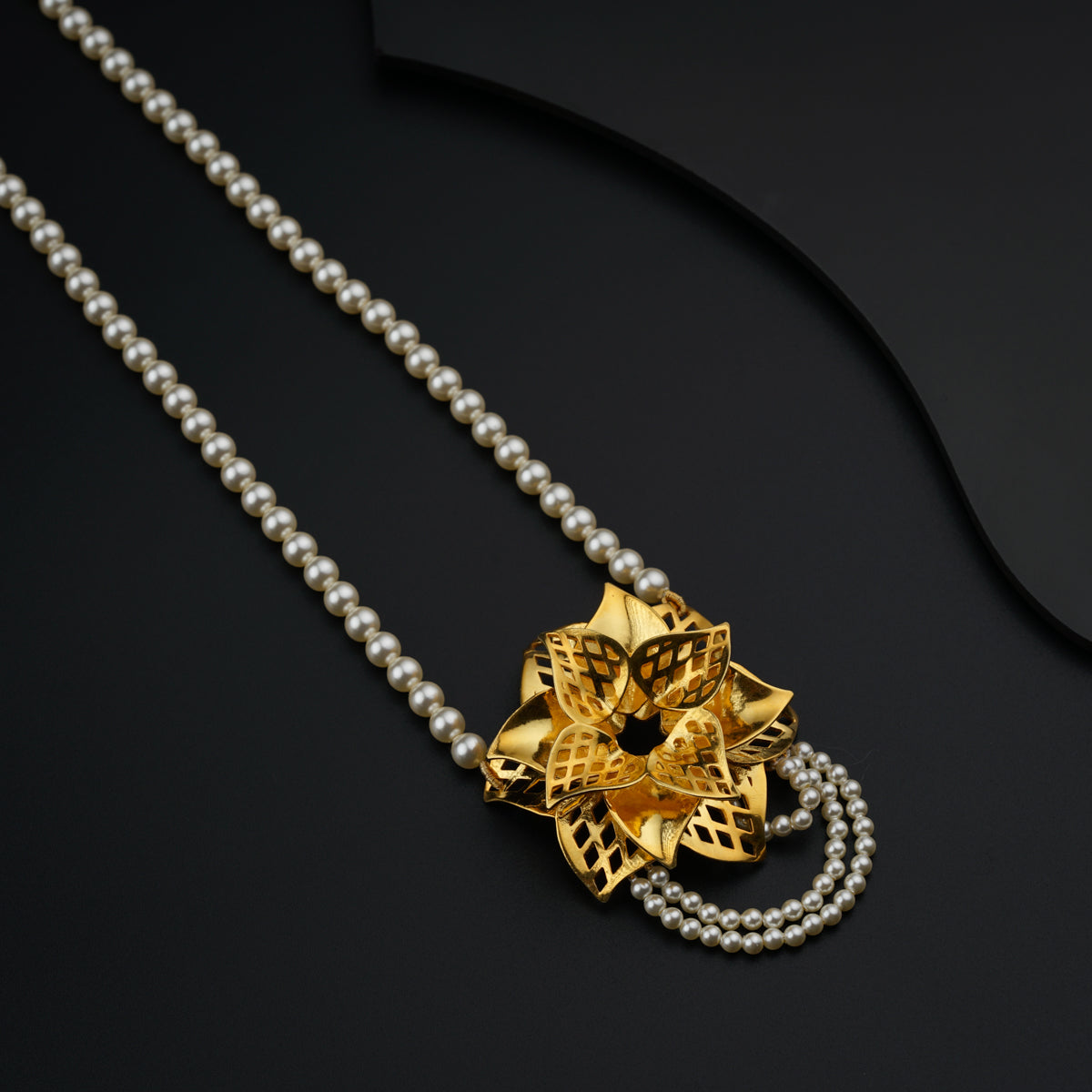 a necklace with a gold flower on it