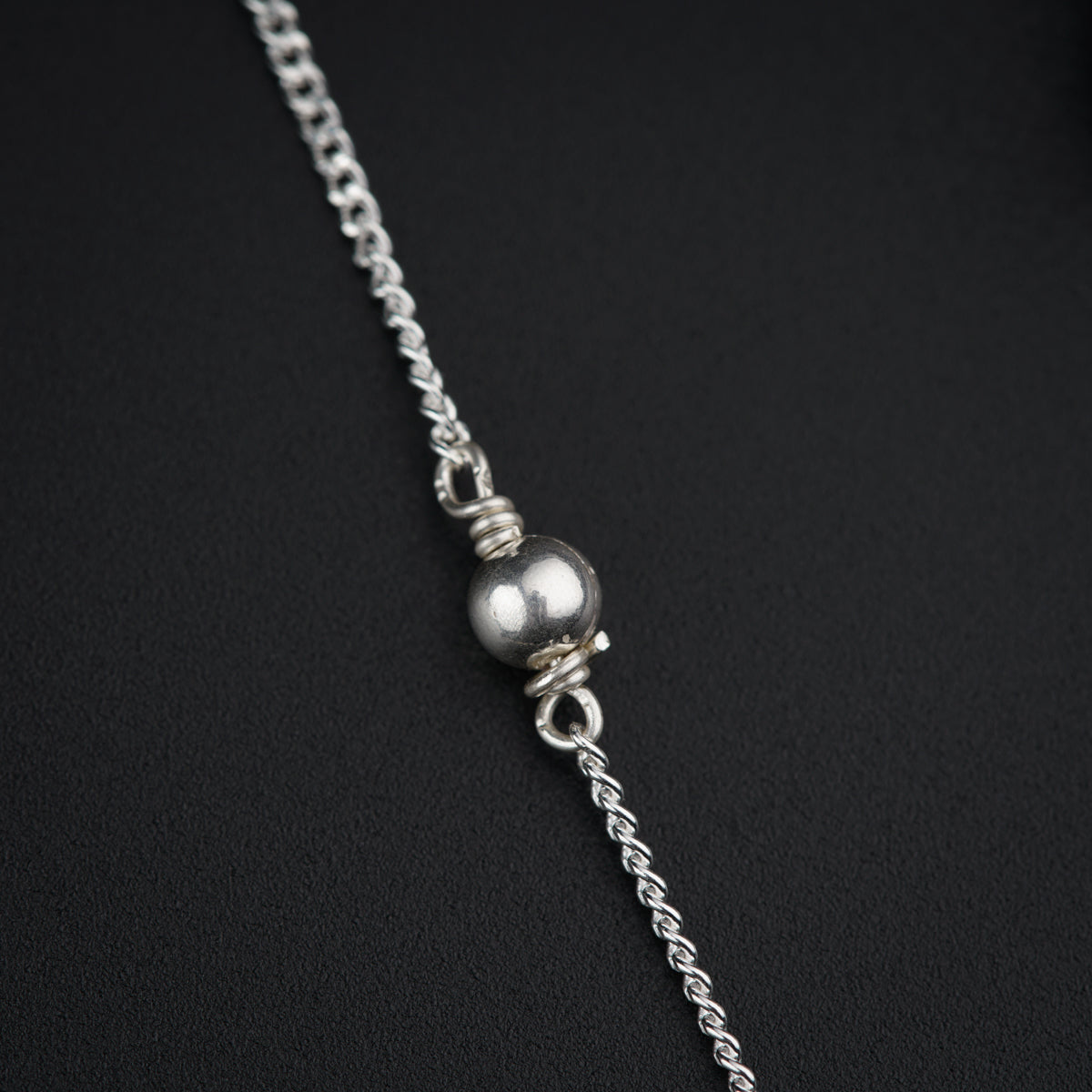 a close up of a chain with a ball on it