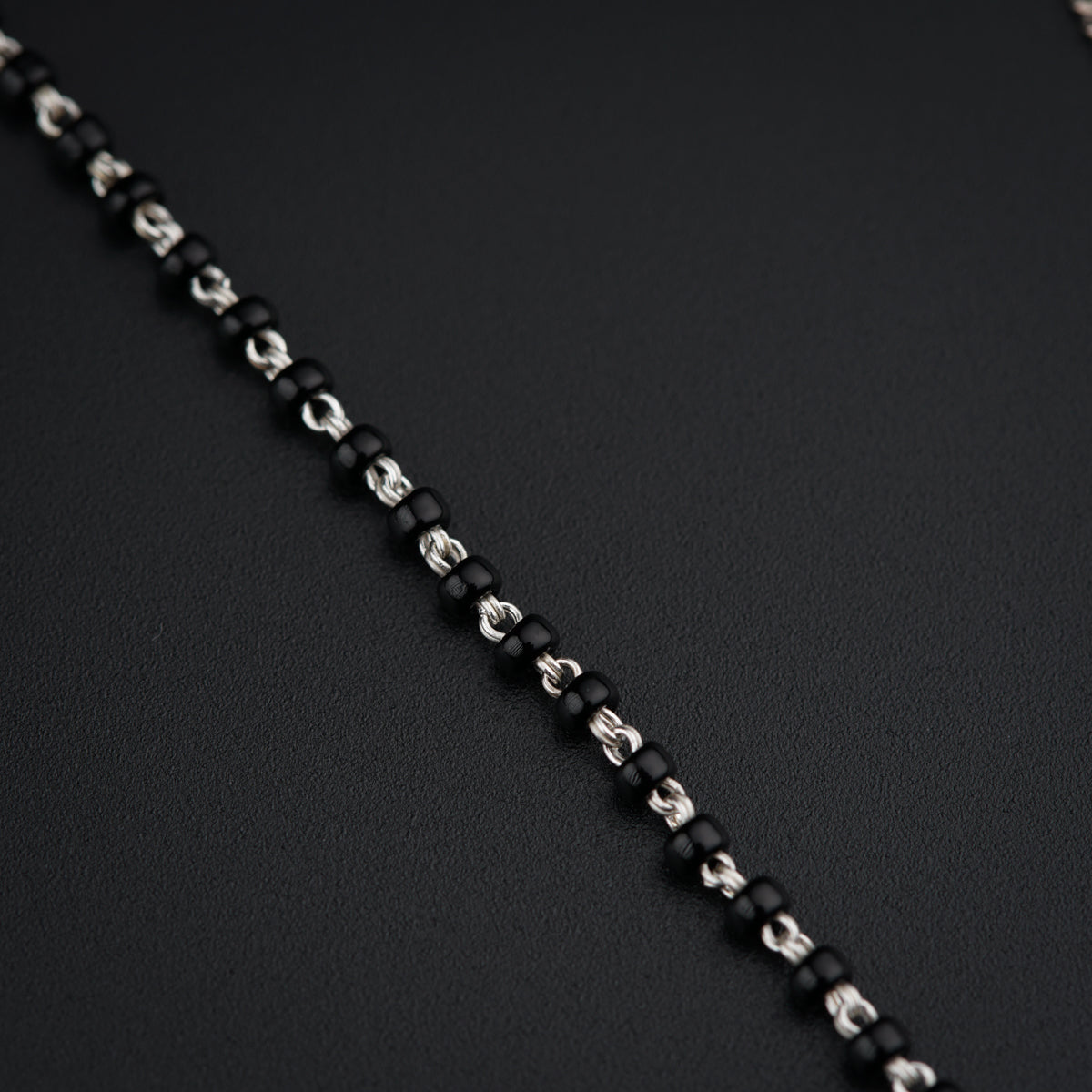 a close up of a chain on a black surface