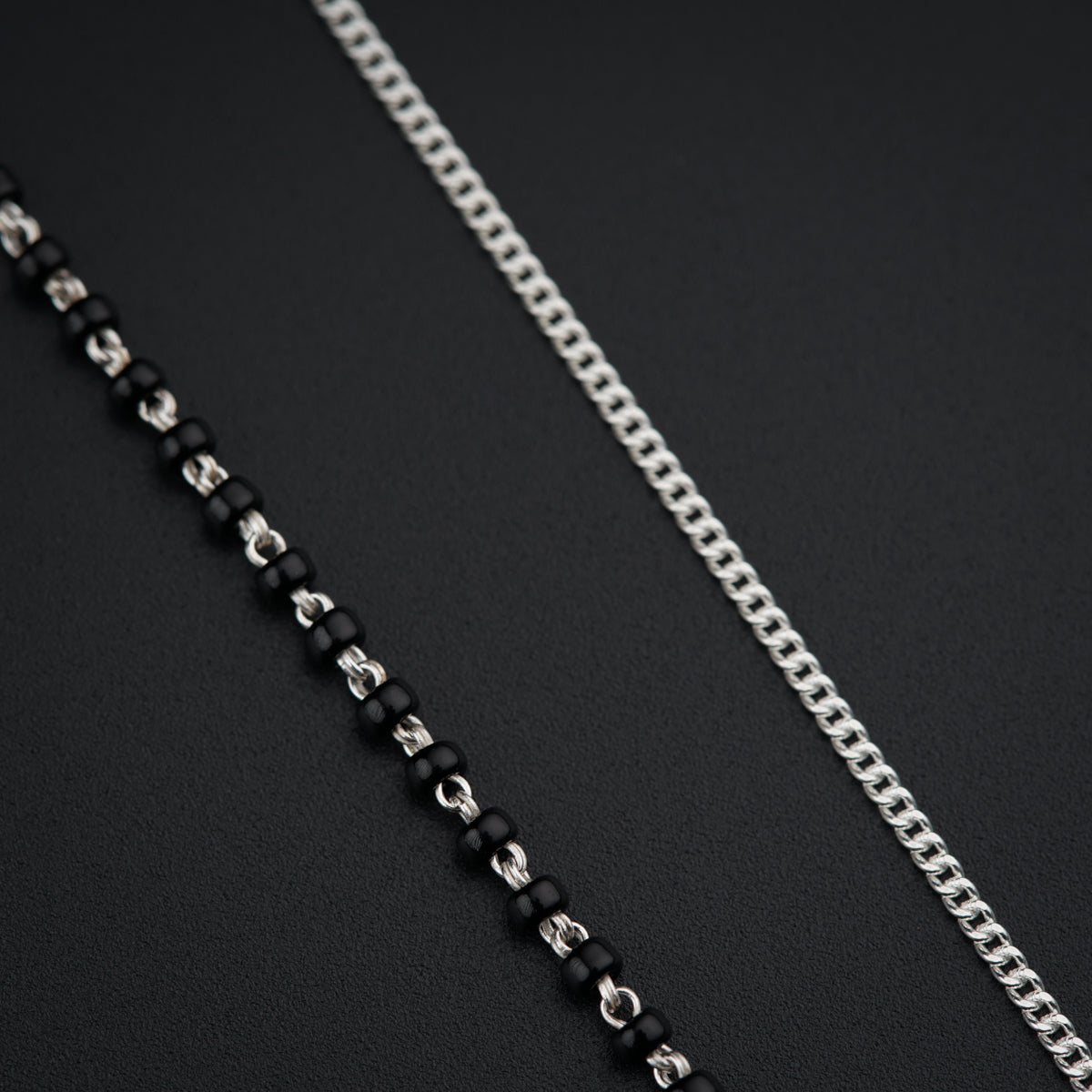 a black and white chain with a silver clasp