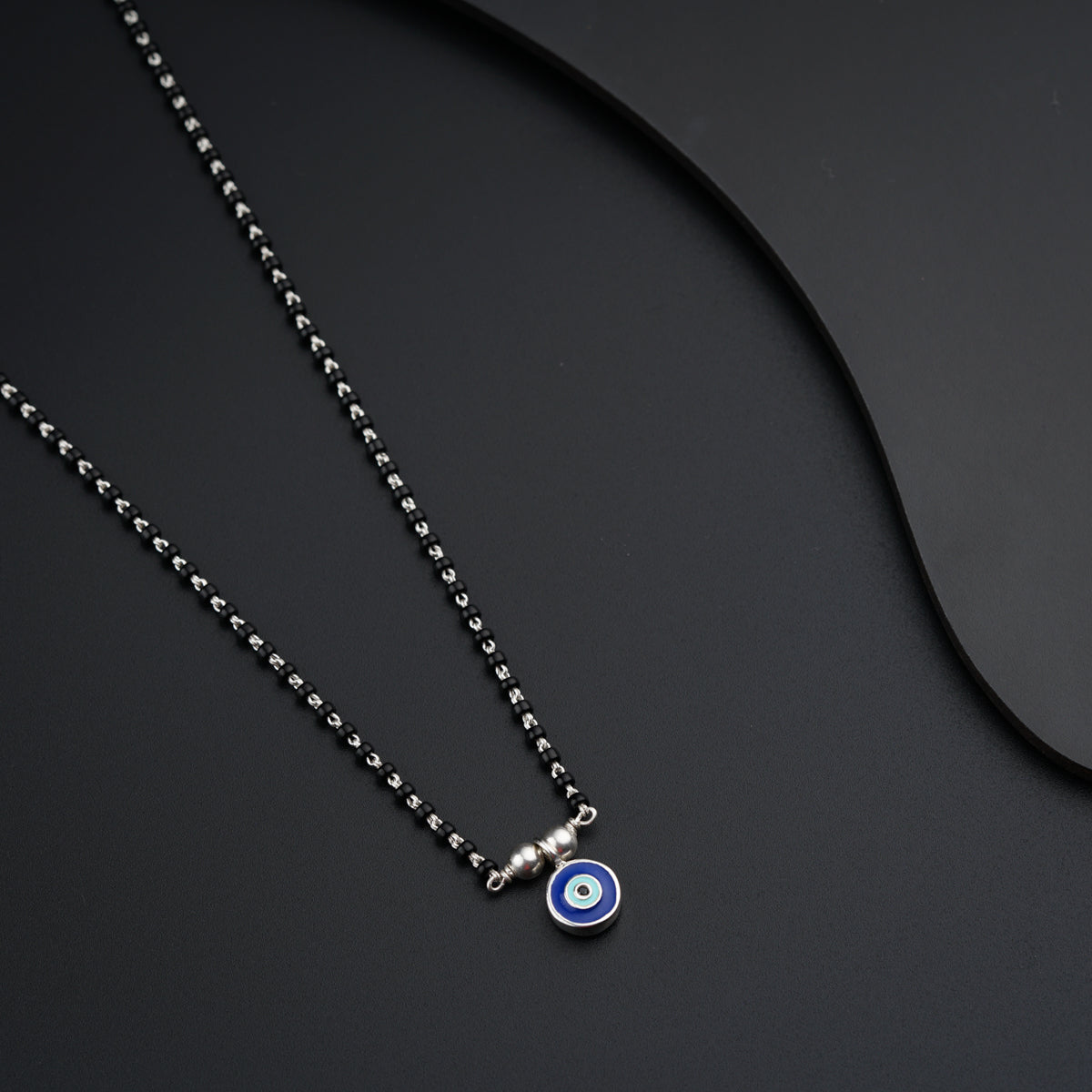 a necklace with a evil eye on it