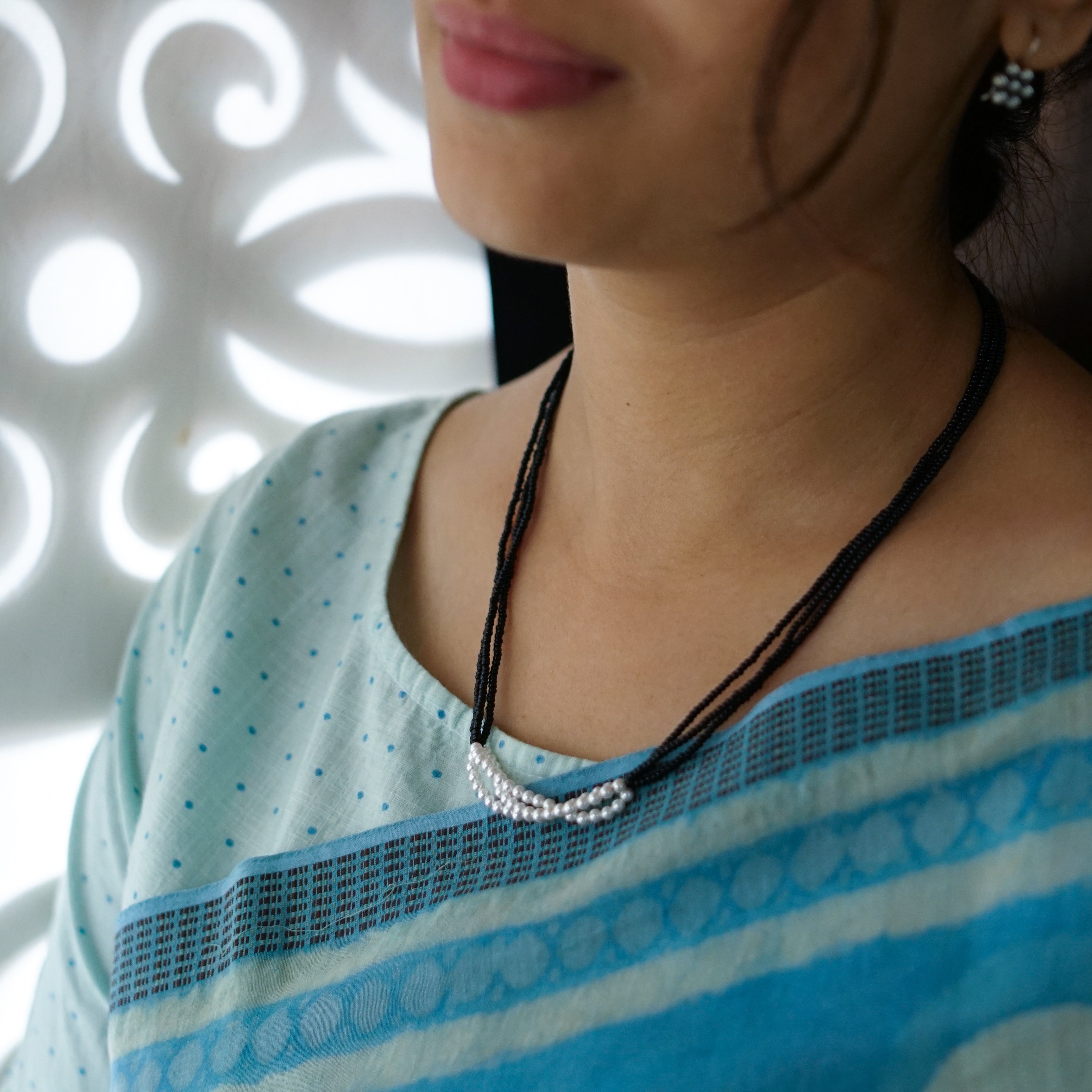 a close up of a person wearing a necklace