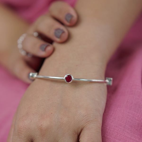 Silver bracelet with red semi precious stone