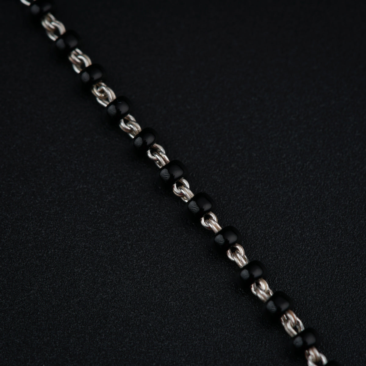a close up of a chain on a black surface