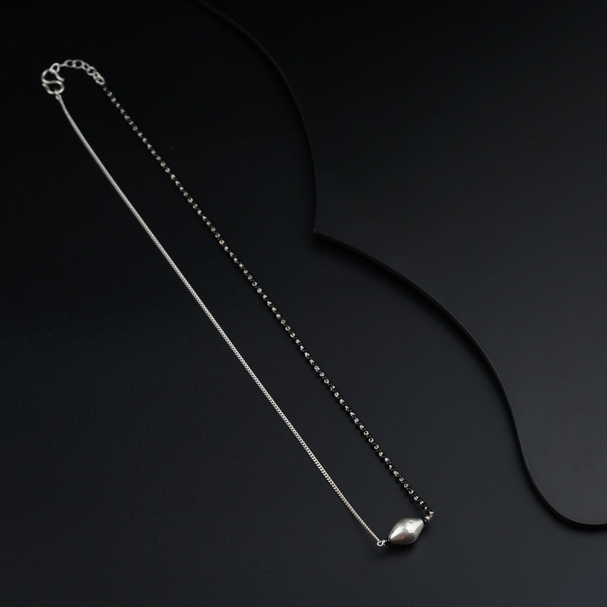 a necklace with a ball on a chain