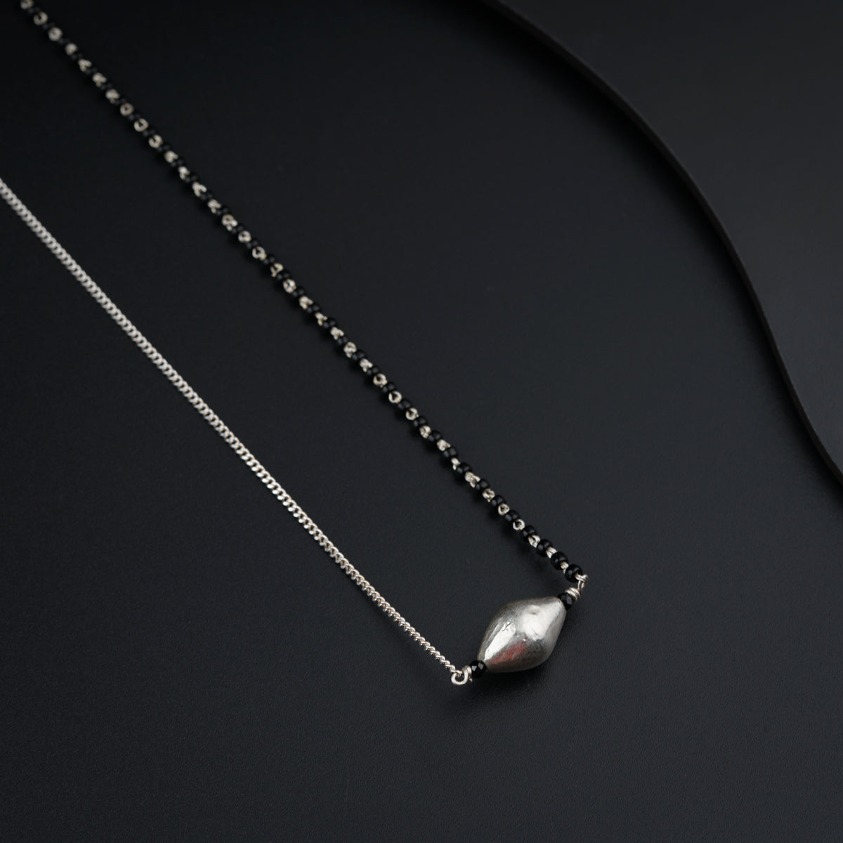 a couple of necklaces sitting on top of a table