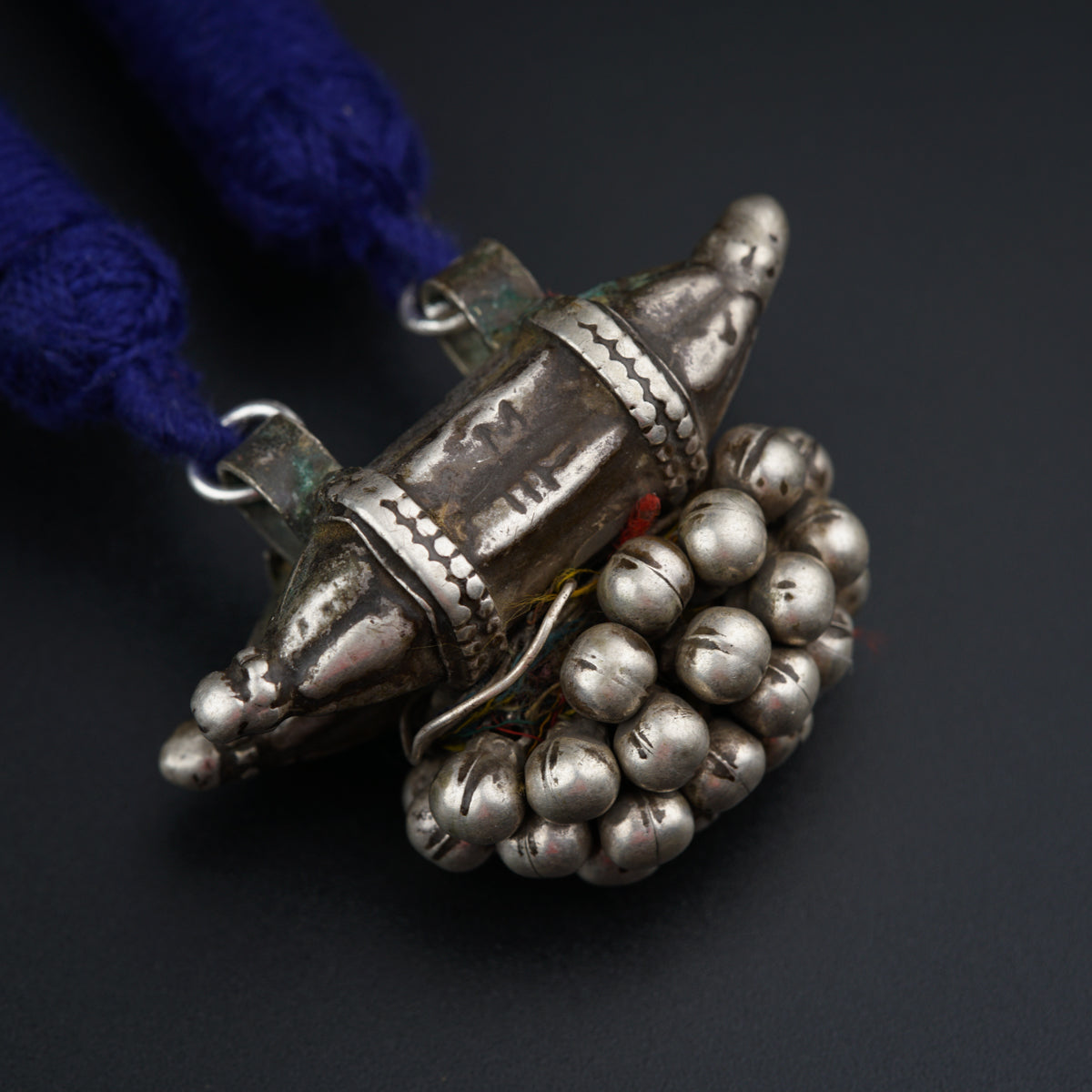 a silver object with bells attached to it