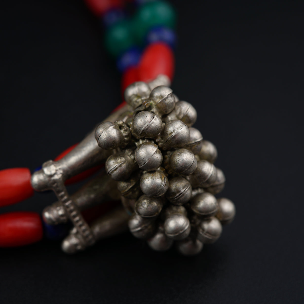 a bunch of silver beads sitting on top of a table