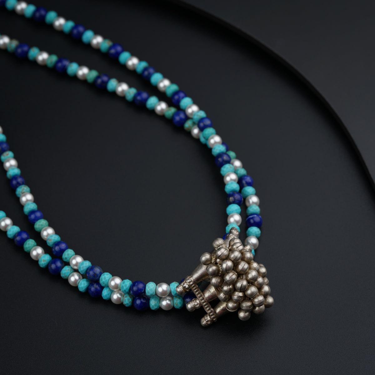 a blue beaded necklace with a silver clasp