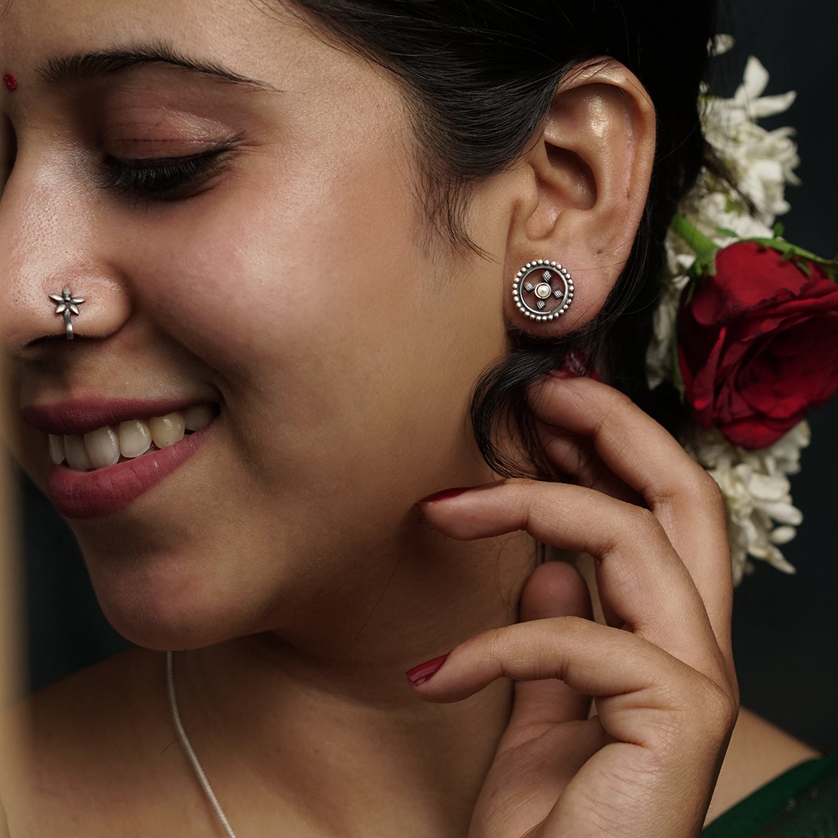 Silver dotted diamond stud earrings close-up handcrafted detailing