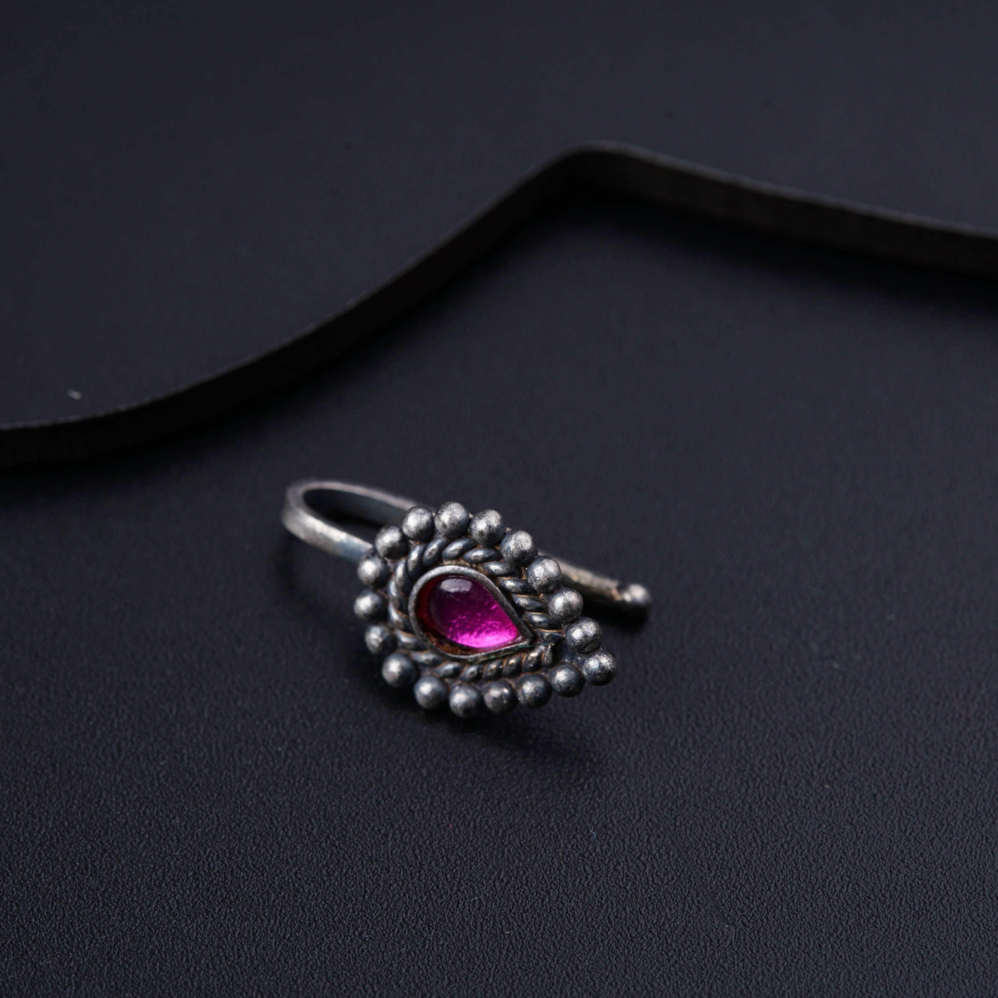 a close up of a ring on a black surface