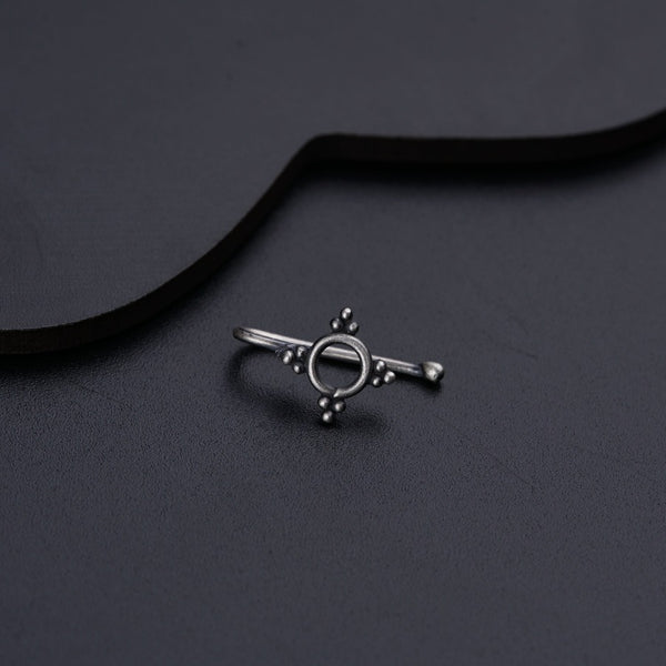 a silver ring on a black background