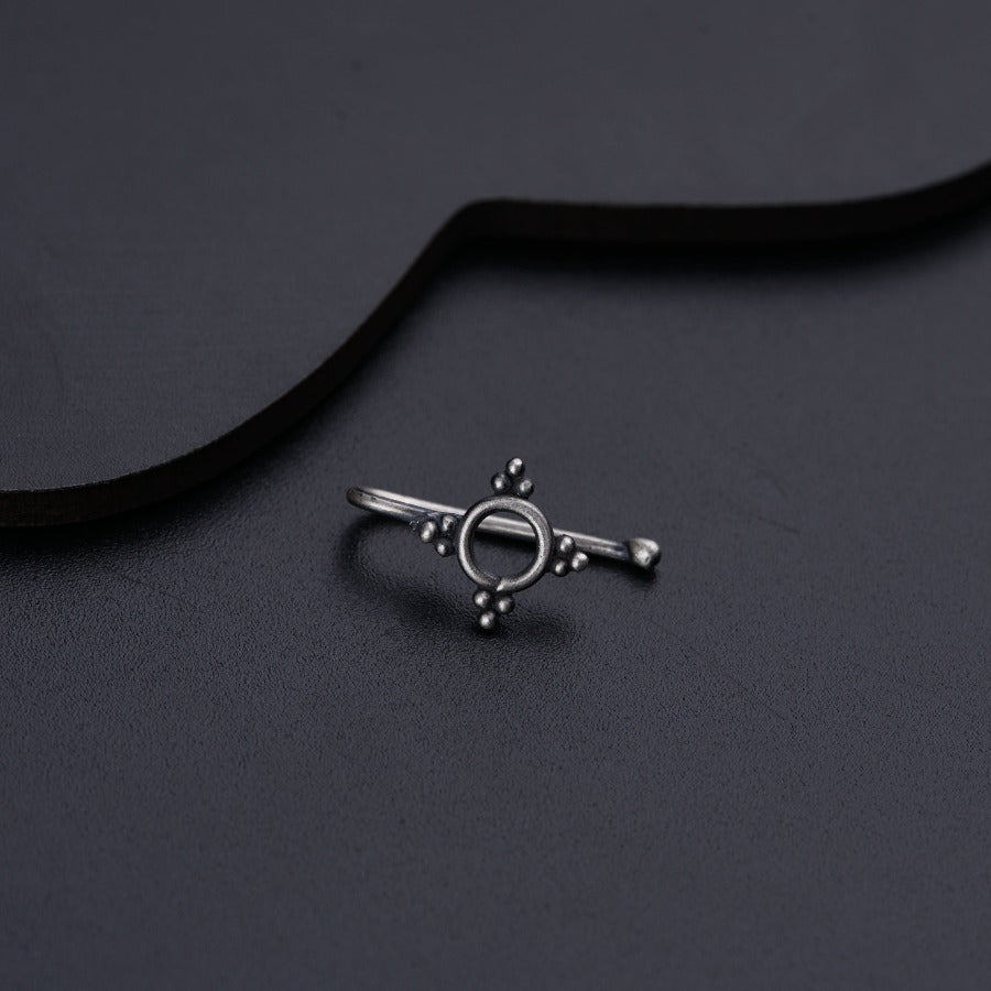 a silver ring on a black background