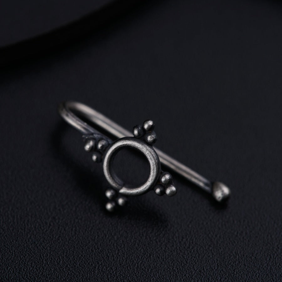 a close up of a metal object on a black surface