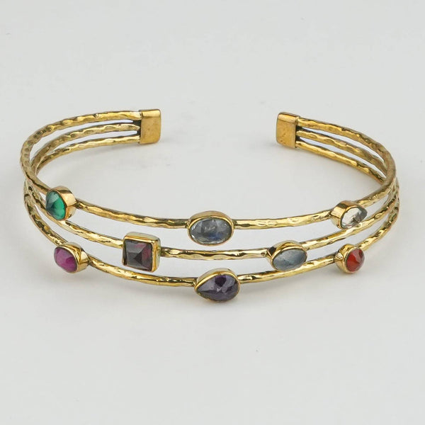Close-up of a brass fashion bracelet showcasing intricate detailing, textured elements, and fine craftsmanship