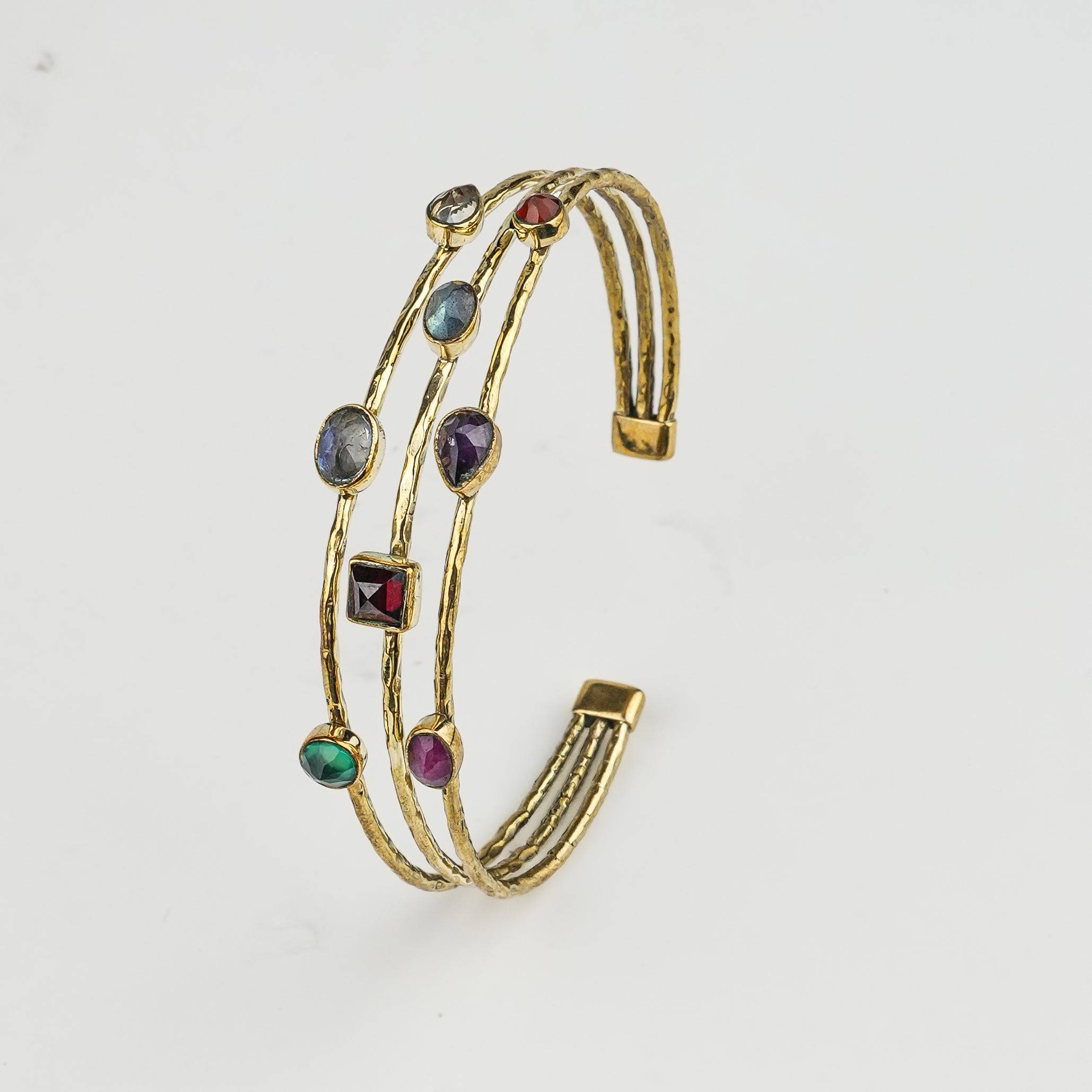Detailed view of a brass fashion bracelet highlighting intricate motifs, textured surface, and refined brass finish