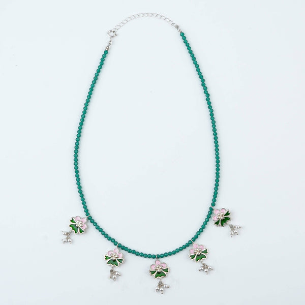 Flat-lay of Pink & Green Enamel Charm Necklace with Green Onyx with colorful accessories and complementary silver jewellery