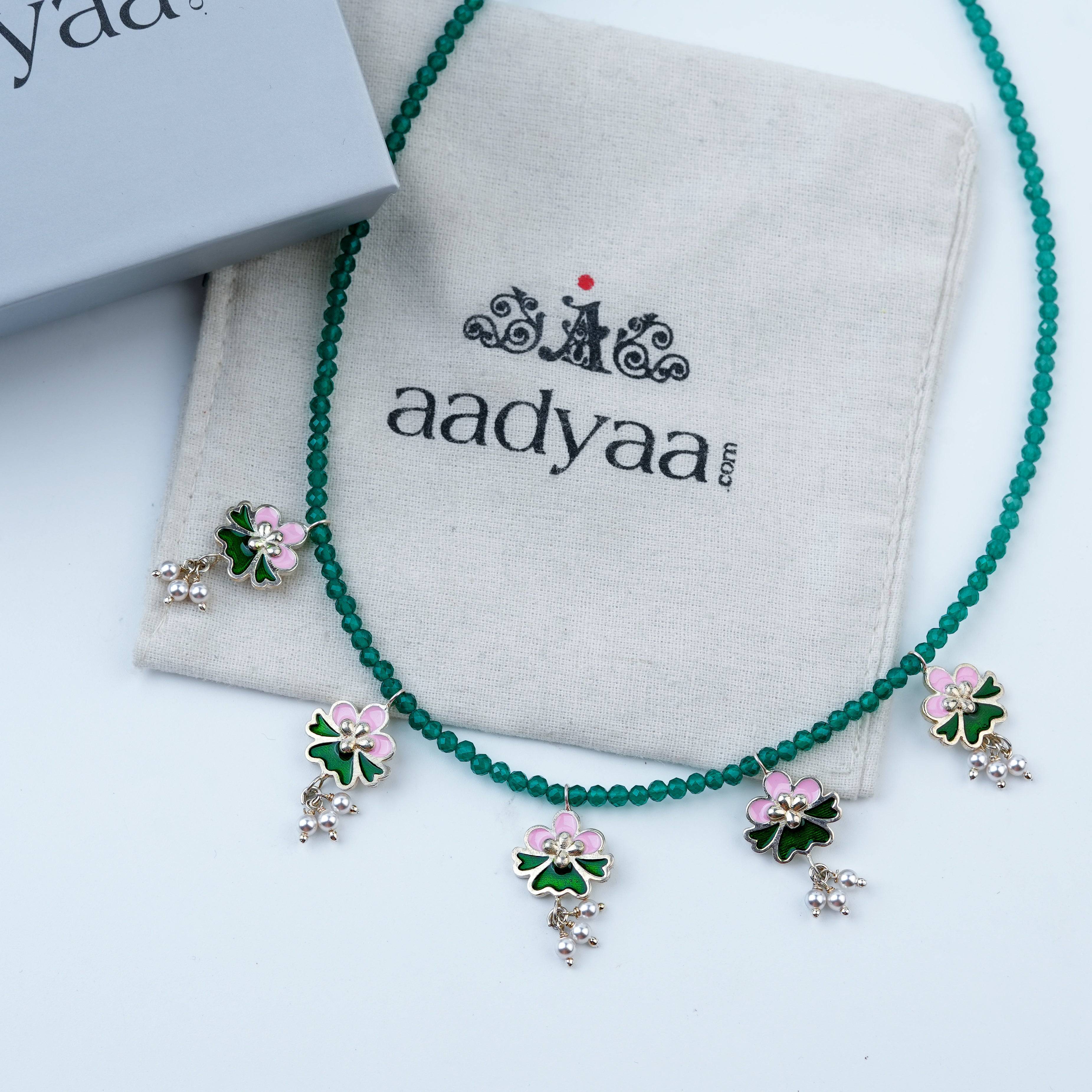 Detailed view of Pink & Green Enamel Charm Necklace with Green Onyx highlighting pink and green enamel charms, green onyx, and polished silver finish