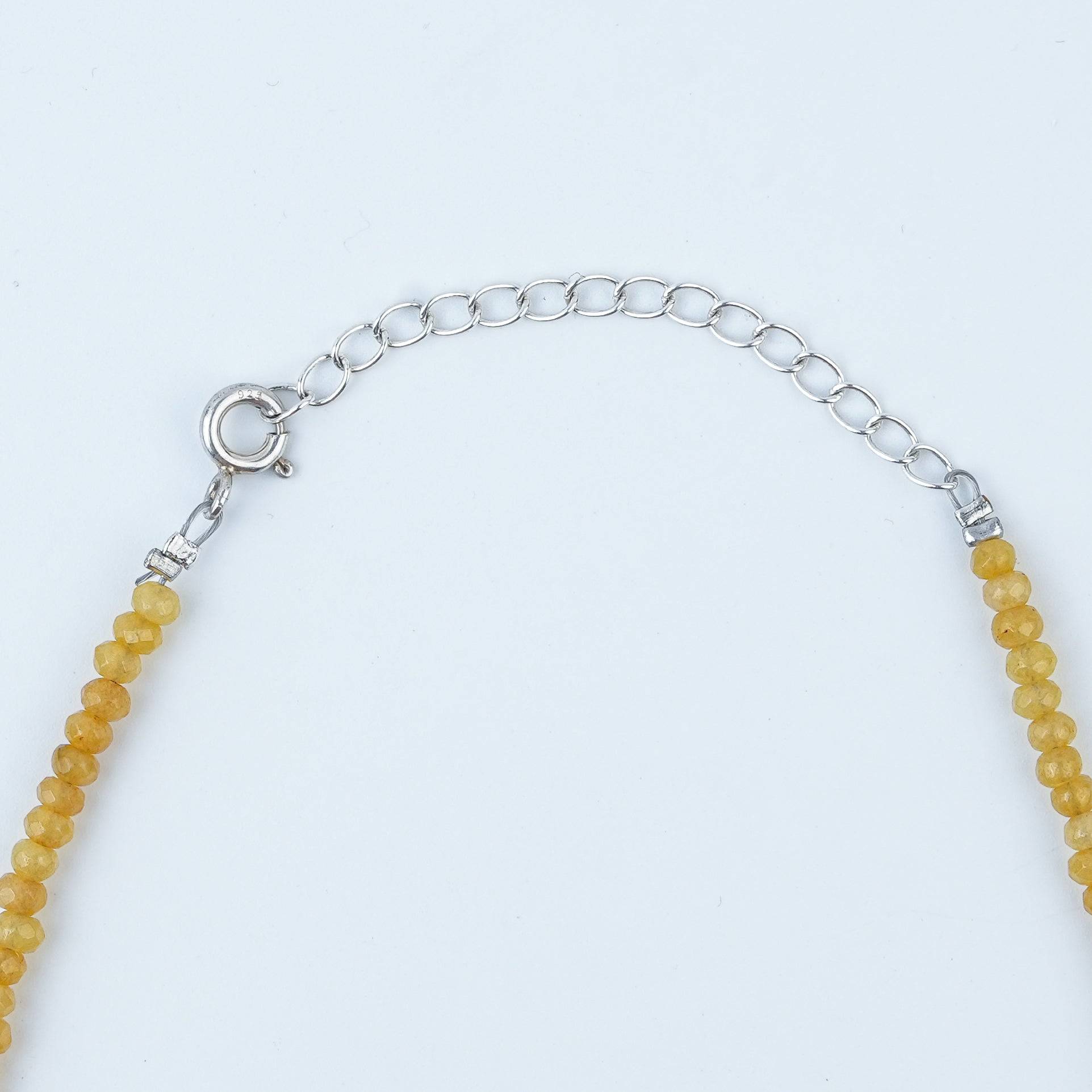 Close-up of Flower & Pearl Charm Necklace with Yellow Jade showcasing floral charms, lustrous pearls, and natural yellow jade
