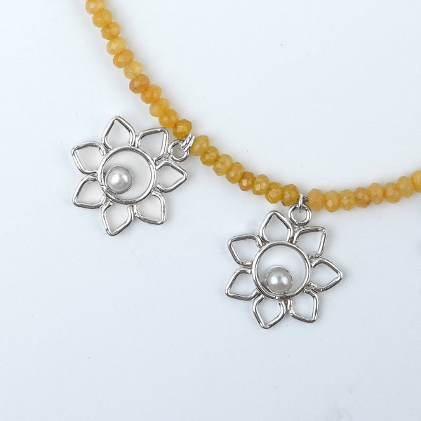 Angled view of Flower & Pearl Charm Necklace with Yellow Jade in 92.5 sterling silver with delicate pearl and floral charms