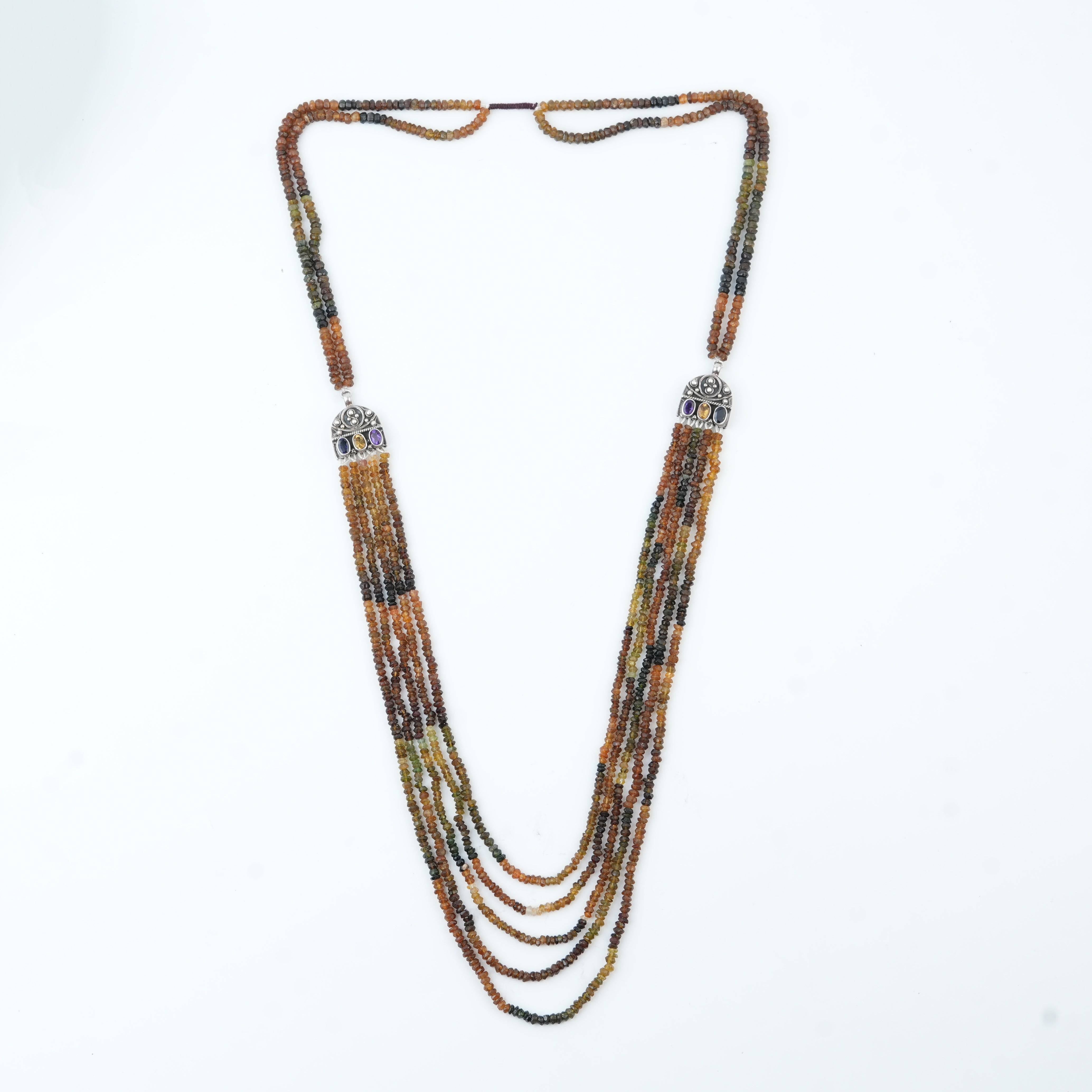 Flat-lay of Silver Tourmaline Layered Necklace with natural tourmaline stones and complementary silver jewellery