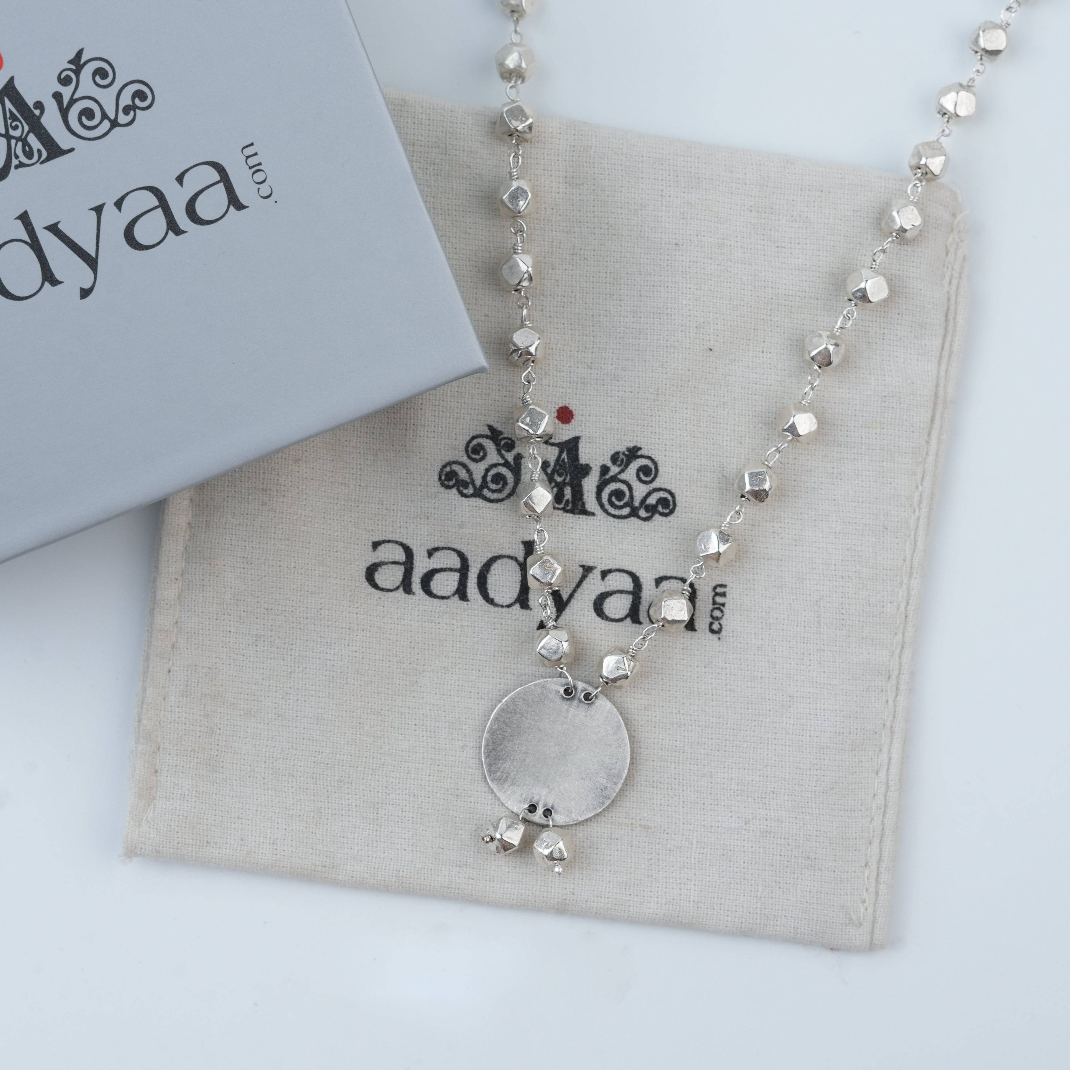 Detailed view of Ashtapailu Necklace with Plain Coin Pendant highlighting the smooth coin pendant, intricate beadwork, and polished silver finish