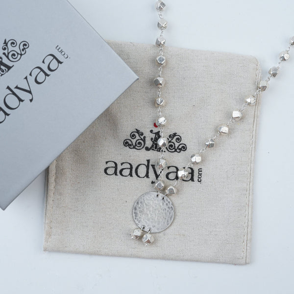 Detailed view of Ashtapailu Necklace with Hammered Coin Pendant highlighting the hammered coin texture, intricate beadwork, and polished silver finish