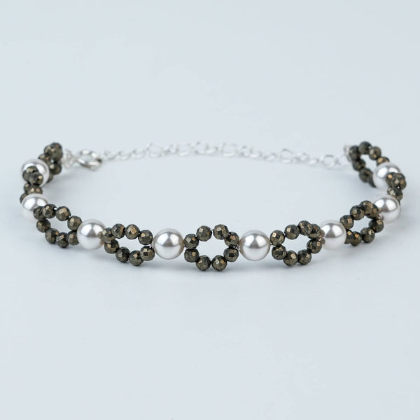 Flat-lay of Silver Pyrite & Pearl Bracelet with natural gemstones, pearls, and complementary silver jewellery