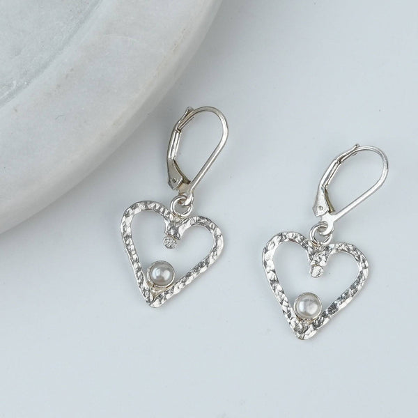 Angled view of Silver Hammered Heart & Pearl Dangle Earrings in 92.5 sterling silver with delicate pearl drops