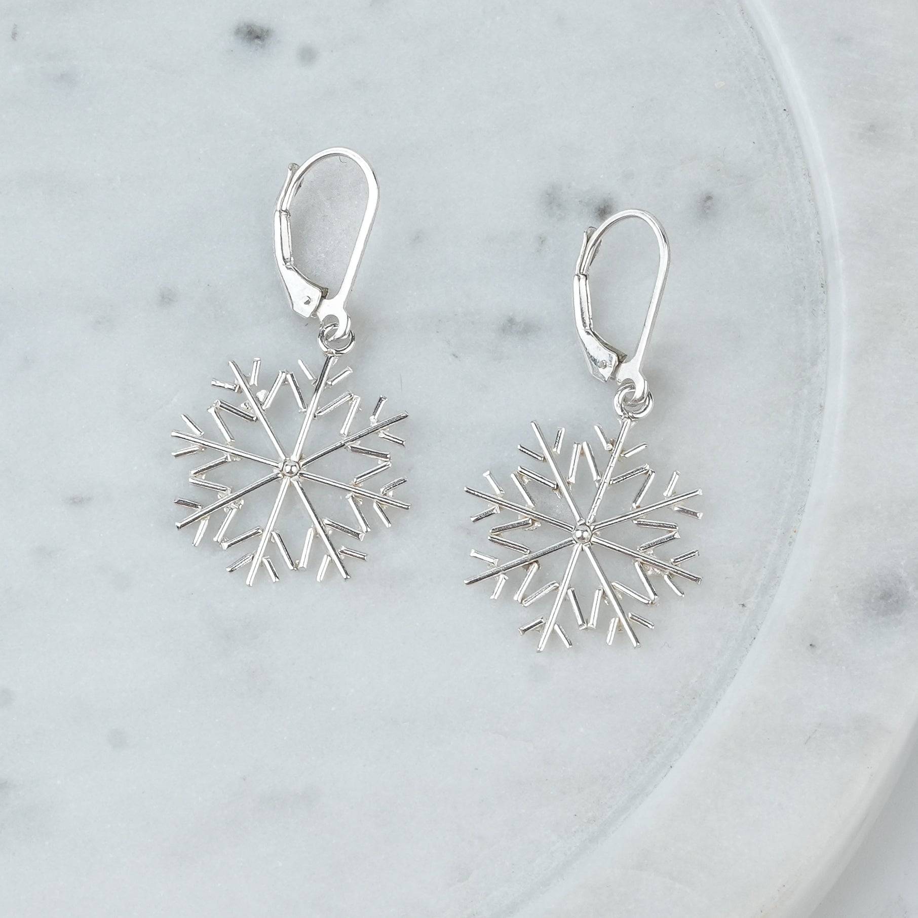 Angled view of Silver Snowflake Dangle Earrings in 92.5 sterling silver with a delicate dangling design