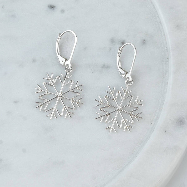Angled view of Silver Snowflake Dangle Earrings in 92.5 sterling silver with a delicate dangling design
