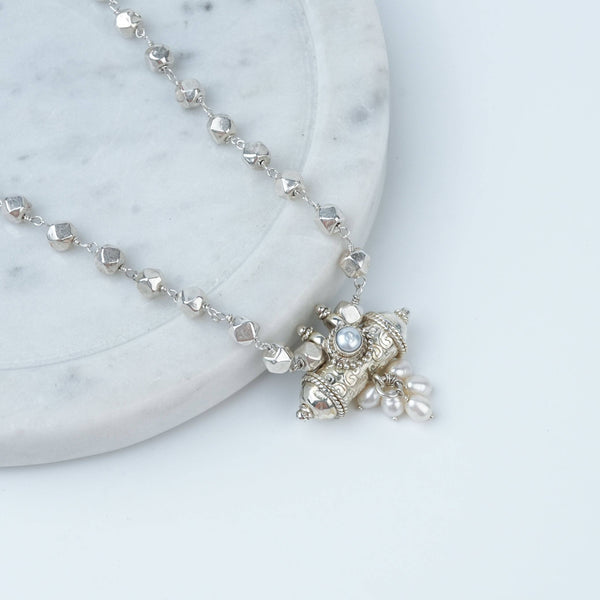 Angled view of Ashtapailu Necklace with Tait Pendant in 92.5 sterling silver with an elegant traditional pendant