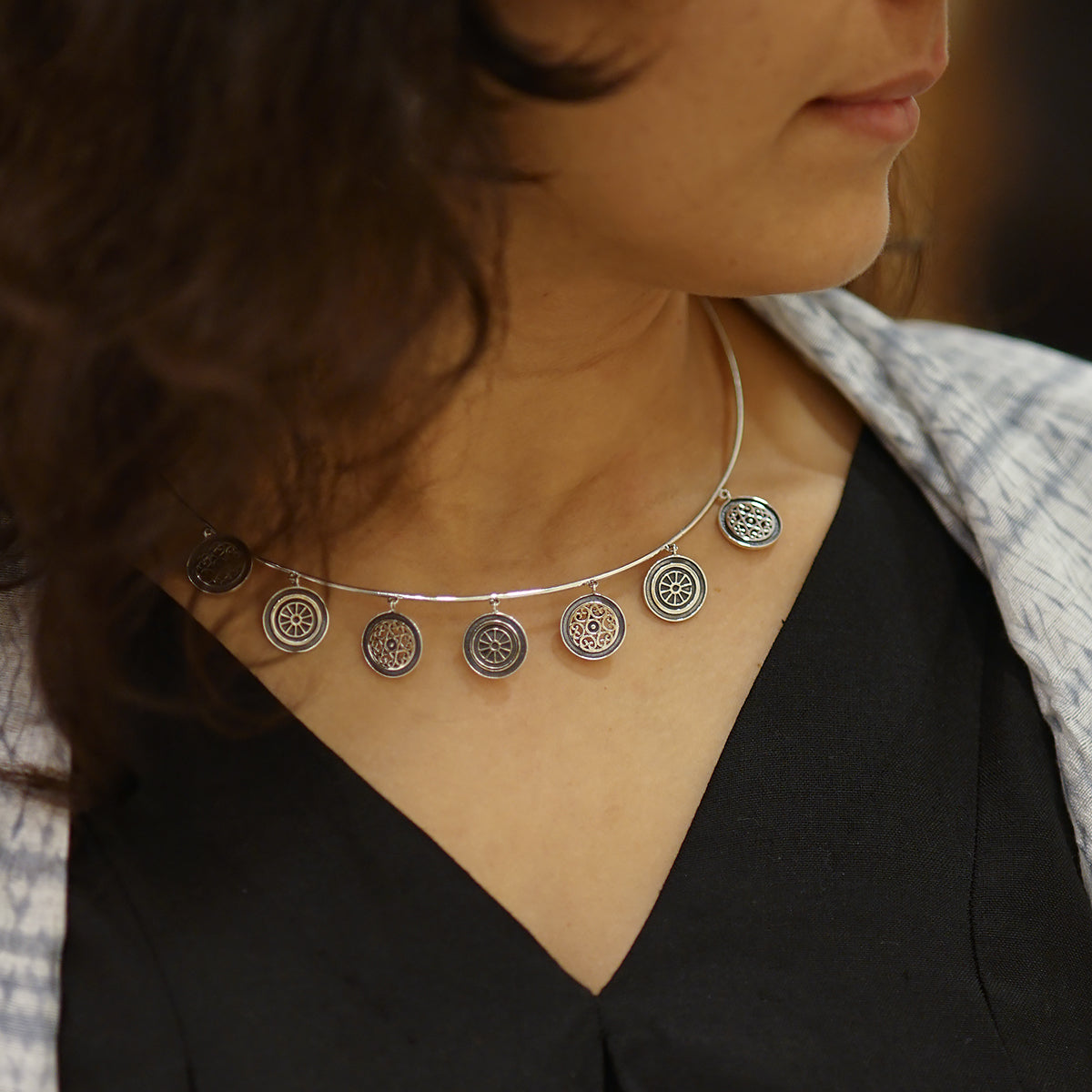 a close up of a woman wearing a necklace
