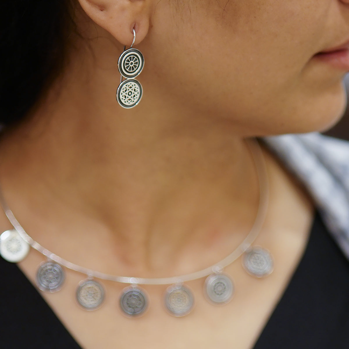 a close up of a person wearing a necklace