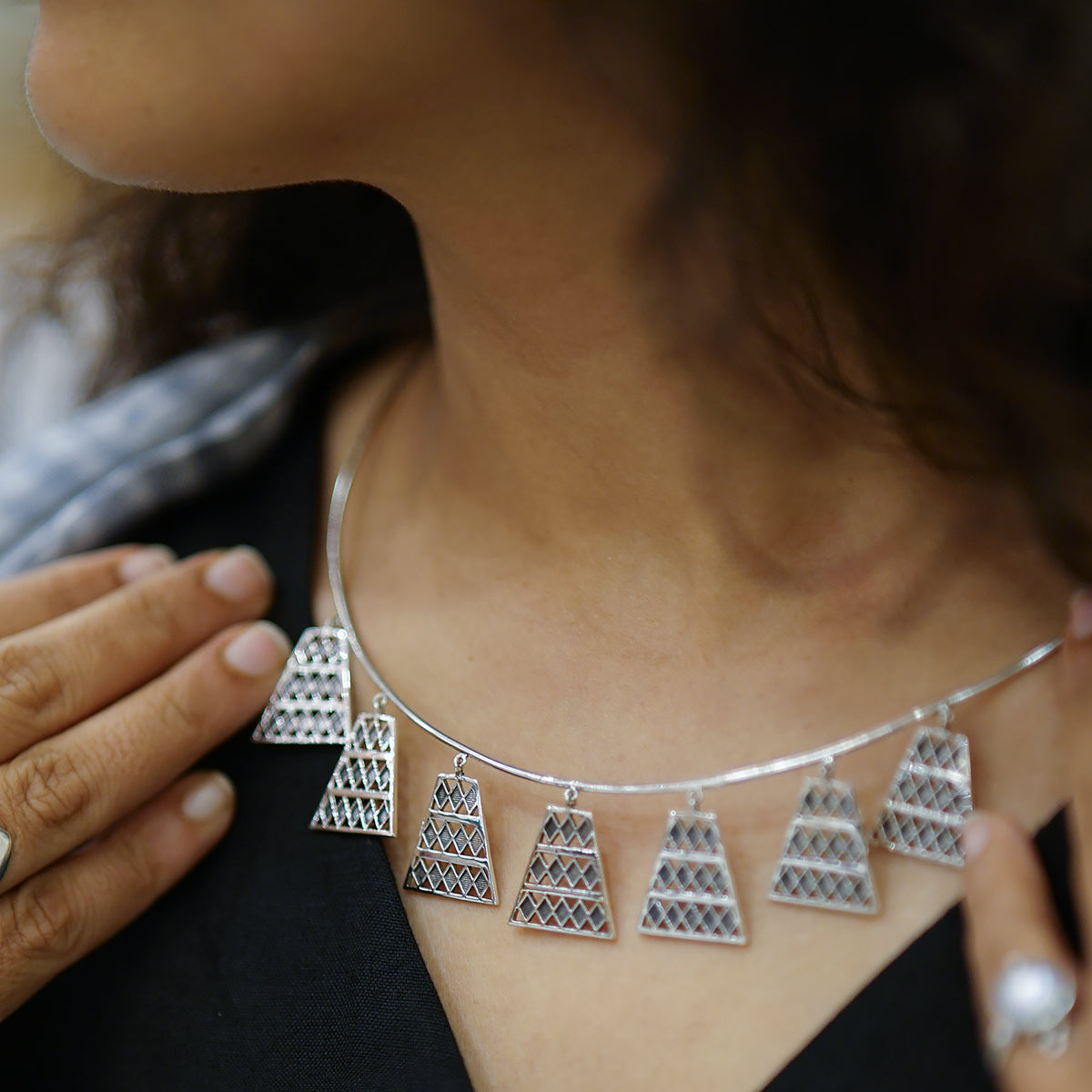 a close up of a woman wearing a necklace