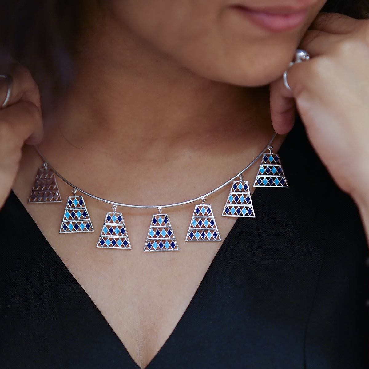 a close up of a person wearing a necklace