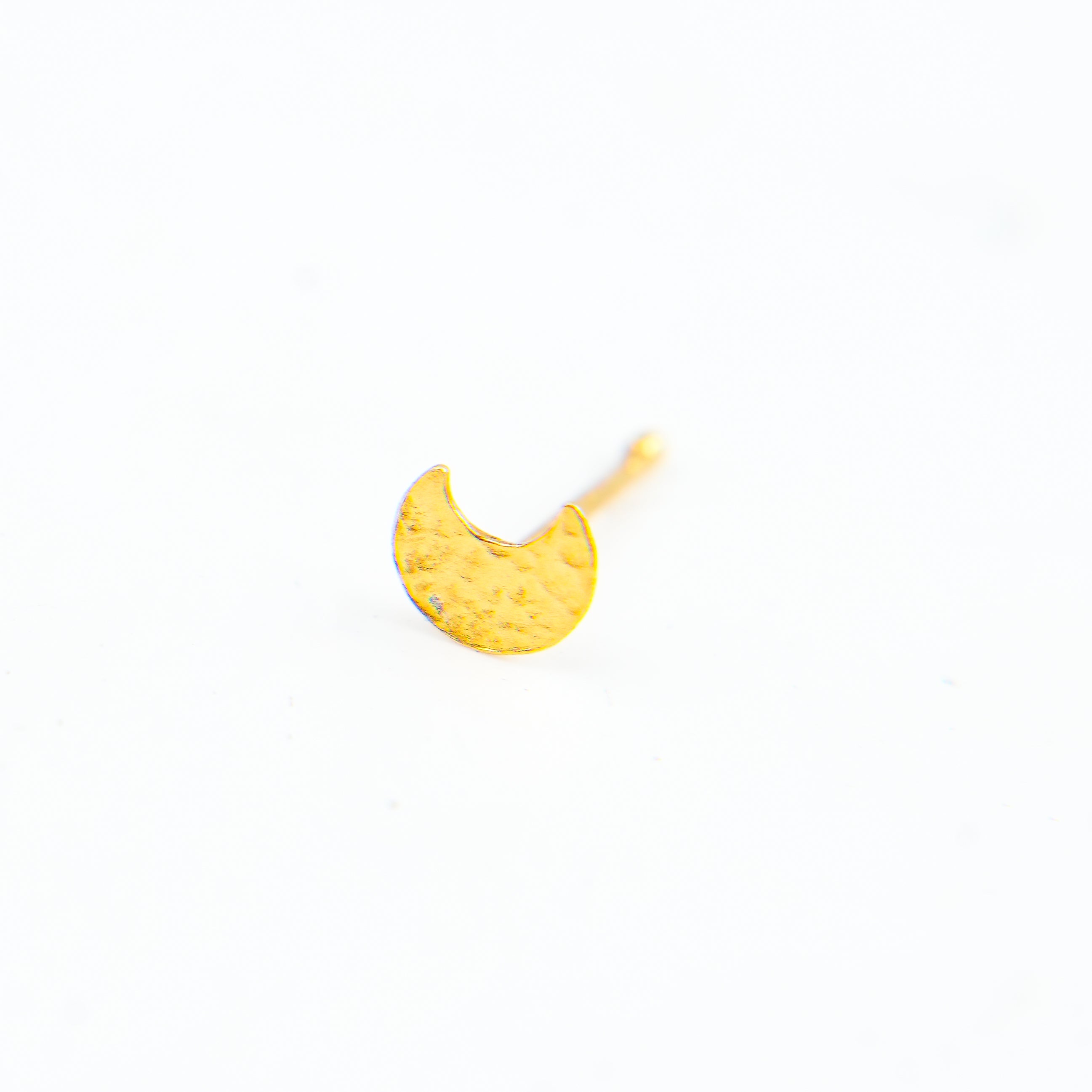 Gold nose pin on model's nose