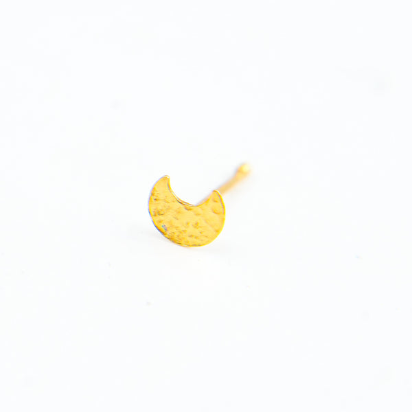 Gold nose pin on model's nose